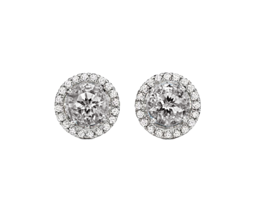 A 0.75-carat round-cut Diamond set in a double halo of 0.50-carat pavé diamonds. Crafted in 18K white gold with additional pavé diamonds on the band, bringing the total carat weight to 1.25.