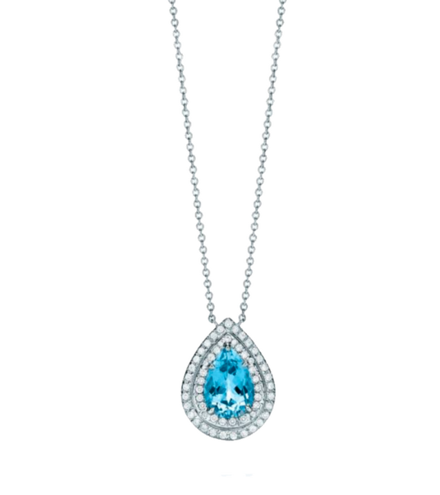This necklace features a 1.5-carat pear-shaped aquamarine, set as the centerpiece within a double halo of 0.3-carat round diamonds, all crafted in premium white gold. The aquamarine’s soft blue tone beautifully contrasts with the sparkling diamonds for a f