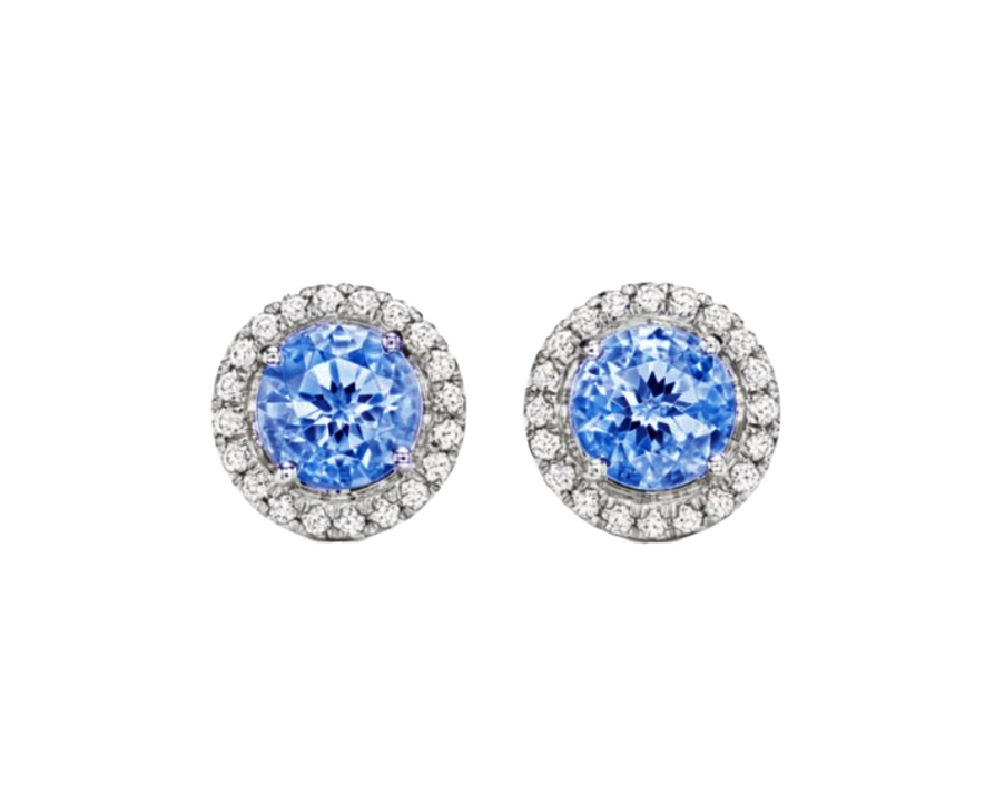 A 0.75-carat round-cut Sapphire set in a double halo of 0.50-carat pavé diamonds. Crafted in 18K white gold with additional pavé diamonds on the band, bringing the total carat weight to 1.25.