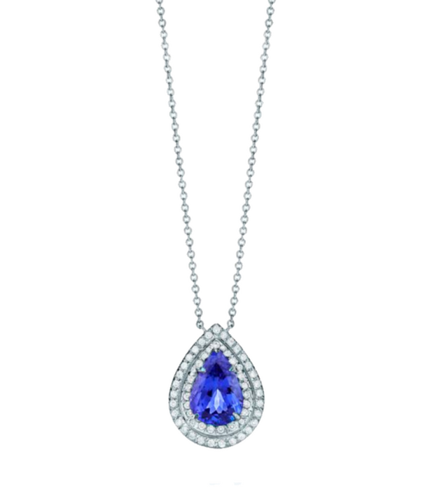 This sophisticated necklace highlights a 1.5-carat pear-shaped sapphire at its core, surrounded by a double halo of 0.3-carat round diamonds, all crafted in premium white gold. The sapphire’s deep blue hue contrasts beautifully with the sparkling diamonds