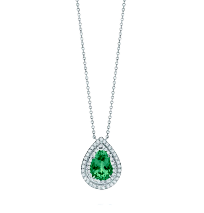 This piece features a 1.5-carat pear-shaped emerald as its focal stone, encircled by a double halo of 0.3-carat round diamonds, set in fine white gold. The emerald’s vivid green hue is enhanced by the sparkling diamonds for a bold and balanced design.