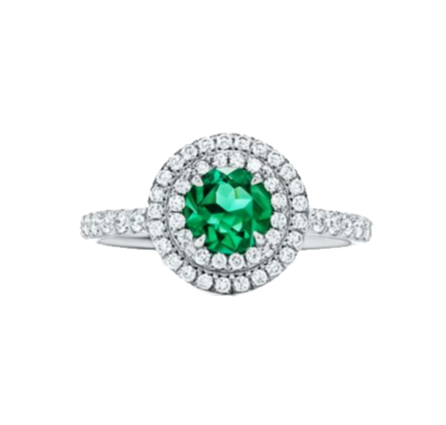 A 0.75-carat round-cut Emerald set in a double halo of 0.50-carat pavé diamonds. Crafted in 18K white gold with additional pavé diamonds on the band, bringing the total carat weight to 1.25.